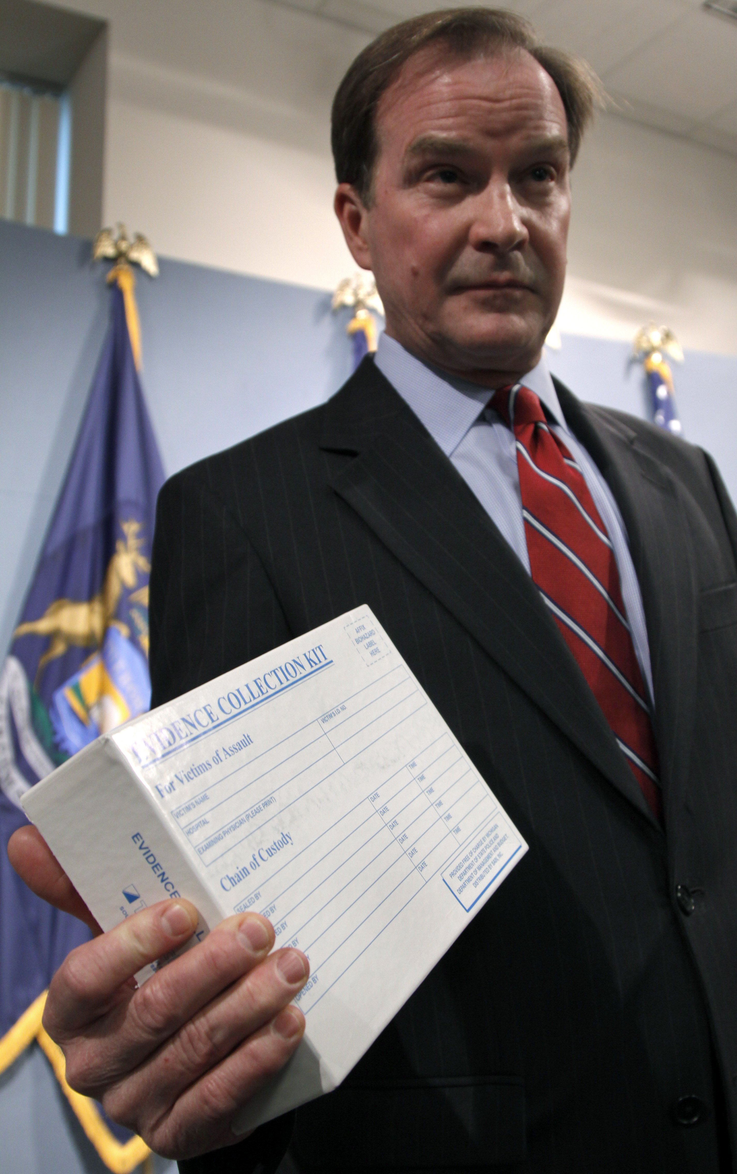 Michigan Attorney General Bill Schuette holds a sexual assault evidence kit at a June 5, 2013 news conference in Lansing, Mich. After taking Detroit's crime lab in 2008, the state discovered more than 11,000 untested rape-evidence boxes dating back 25 years. 