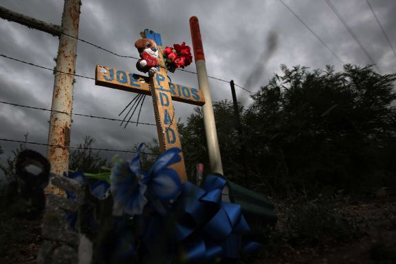 A cross dedicated to oil field worker Joe Rios marks the location outside Long Vista RV Park where a van carrying oil field workers collided with a school bus along Highway 72 on Jan. 30, 2014, in Three Rivers. There was three oilfield workers who died, and no students were injured.