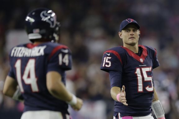 Houston Texans backup quarterback Ryan Mallett (15) congratulates quarterback Ryan Fitzpatrick (14) as he comes off the field during the second quarter of an NFL football game, Thursday, Oct. 9, 2014, in Houston. (AP Photo/Patric Schneider)