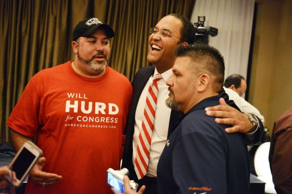 Republican congressional candidate Will Hurd, center, greets his brother, Charlie, left, during an election night watch party. Hurd carried the San Antonio area to capture U.S. House District 23 from Democrat Pete Gallego. 
﻿