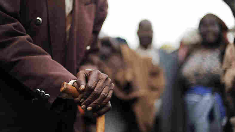 A Kenyan senior citizen leans on his cane. As people age in parts of Africa, they report declining levels of satisfaction with their life.