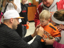 Browns quarterback Brian Hoyer signs a young fan's shirt during an autograph signing  benefiting Coats for Kids Tuesday night at the Fairview Park Mr. Hero. / (Photo by Daryl Ruiter CBS Cleveland)