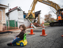 John Bello, age two, plays while his mother attends press conference about New York state's program to buy back homes destroyed by Hurricane Sandy and allow mother nature to reclaim the land, two years after Superstorm Sandy damaged the area, on October 29, 2014 in the Oakwood Beach neighborhood of Staten Island.  (Photo by Andrew Burton/Getty Images)