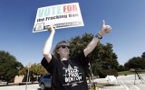 President of Denton Drilling Awareness, Cathy McMullen, right, gives a thumbs up to passing motorist at the Denton Civic Center in Denton, Thursday, Oct. 30, 2014.