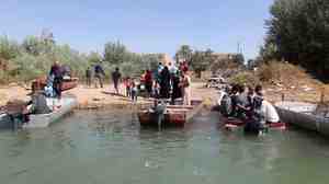 Citizens of Dhuluiyah, Iraq, must take boats to get in an out, since one of the town's two bridges was blown up by the Islamic State and the other was commandeered by tribesmen defending them.