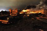 A vehicle near the remains of a fertilizer plant burning after an explosion in West, Texas, near Waco.