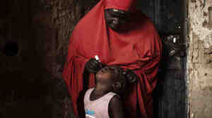 A child receives a polio vaccine during National Immunization Days in the Nigerian city of Kano.