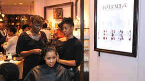 Real Housewives of Atlanta star Lisa Wu Hartwell gets a hair treatment at a "Curl Party" hosted by Carol's Daughter and theYBF.com in 2010.