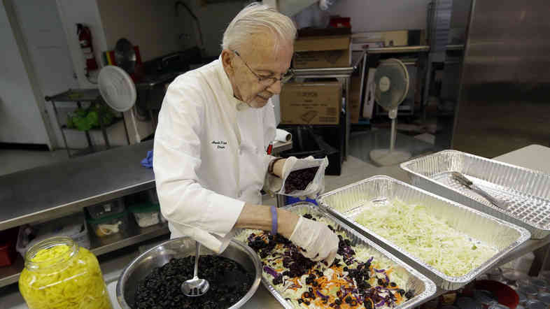 Homeless advocate Arnold Abbott, 90, director of the nonprofit group Love Thy Neighbor Inc., prepares a salad in the kitchen of The Sanctuary Church, Wednesday, Nov. 5, 2014, in Fort Lauderdale, Fla. Abbott was recently arrested,  along with two pastors, for feeding the homeless in a Fort Lauderdale park.