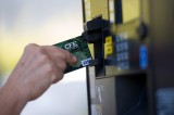 A woman slides her credit card to buy gasoline in San Francisco, Calif. (David Paul Morris/Bloomberg)