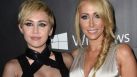 Actress Miley Cyrus (L) and her mother Tish Cyrus attend amfARs fifth annual Inspiration Gala in Los Angeles, October 29, 2014 at Milk Studios in Hollywood, California.