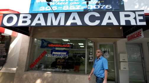 Hisham Uadadeh walks out of Leading Insurance Agency after enrolling in a health insurance plan under the Affordable Care Act.