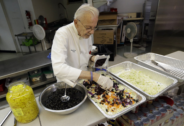Homeless advocate Arnold Abbott, 90, director of the nonprofit group Love Thy Neighbor Inc., prepares a salad in the kitchen of The Sanctuary Church, Wednesday, Nov. 5, 2014, in Fort Lauderdale, Fla. Abbott was recently arrested,  along with two pastors, for feeding the homeless in a Fort Lauderdale park.