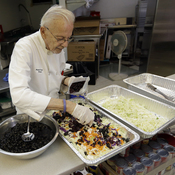 Homeless advocate Arnold Abbott, 90, director of the nonprofit group Love Thy Neighbor Inc., prepares a salad in the kitchen of The Sanctuary Church, Wednesday, Nov. 5, 2014, in Fort Lauderdale, Fla. Abbott was recently arrested,  along with two pastors, for feeding the homeless in a Fort Lauderdale park.