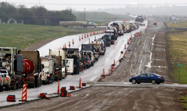  In this 2014 photo, a traffic accident adds to the expansion problems of U.S. Route 85 between Williston and Watford City, N.D. The highway, once a two-lane road across the lonely prairie, is being transformed into a four-lane highway as the state experiences a fossil fuel-driven boom.