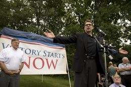 Former New Hampshire Gov. John Sununu looks on as Gov. Rick Perry speaks at a Stratham rally on Saturday.