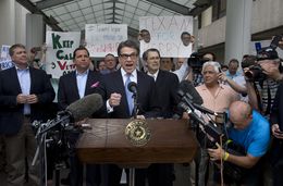 Gov. Rick Perry speaks to the media and supporters after being booked at the Travis County Justice Center on August 19, 2014.