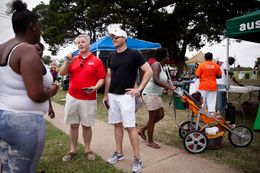 James Dickey, chairman of the Travis County Republican Party (in red), and Brendan Steinhauser, campaign manager for U.S. Sen. John Cornyn (in black), talked to members of the crowd at a Juneteenth celebration in East Austin on Saturday. Steinhauser's visit was part of the Cornyn campaign's efforts to reach diverse communities.