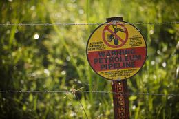 One of the many pipeline markers sprinkled across David Holland's family farm near Beaumont, Texas. Holland is involved in major litigation involving common carrier status against Denbury Resources, which built a pipeline across his land.