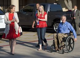 GOP gubernatorial candidate Greg Abbott, with wife Cecilia and daughter Audrey, leaves a south Austin polling place after voting early.