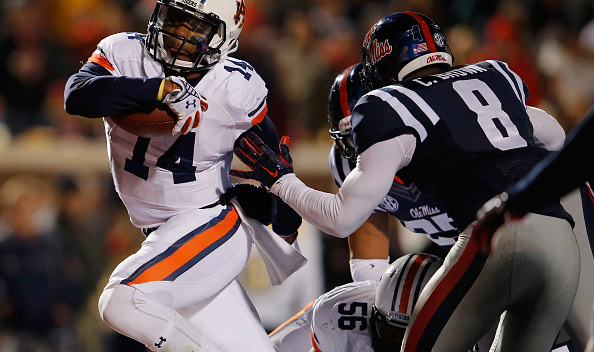 OXFORD, MS - NOVEMBER 01: Quarterback Nick Marshall #14 of the Auburn Tigers rushes 2 yards for a touchdown against Chief Brown #8 of the Mississippi Rebels as the Rebels held a 24-21 lead in the third quarter at Vaught-Hemingway Stadium on November 1, 2014 in Oxford, Mississippi. Auburn defeated Mississippi 35-31. (Photo by Doug Pensinger/Getty Images)
