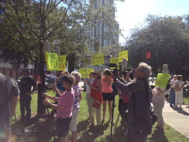 Florida residents hold signs at a protest outside of Duke Energy's St. Petersburg office on Wednesday, Oct. 29, 2014.