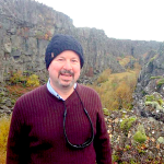 Dr. Michael Mann standing beside the mid-Atlantic ridge on a recent trip to Iceland (cropped from meteo.psu.edu)