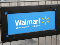 The Walmart logo is displayed on a shopping cart at a Walmart store. (credit: Scott Olson/Getty Images)
