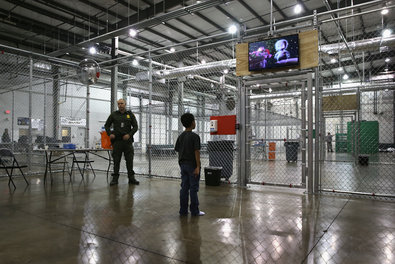 A boy from Honduras watches TV at a Border Patrol detention facility in McAllen, Tex. An overhaul of immigration laws is a tough issue within the Republican Party.
