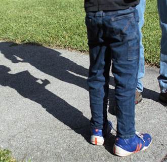 Image: Frank Martin Gill casts a shadow on the ground as he talks with his six-year-old foster son, known as N.R.G. on Sept. 22, 2010 in Miami, Fl. 