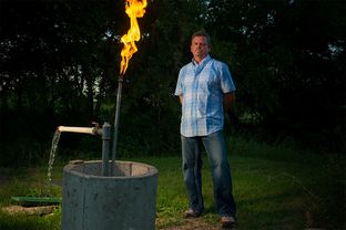 Steve Lipsky shows the methane contamination of his well by igniting the gas with a lighter outside his family's home in Parker County near Weatherford, Texas on June 17, 2014.