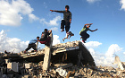 Palestinian youths are seen practicing their parkour skills over the ruins of houses in Khan Younis in that Gaza Strip that were reportedly destroyed during the seven-week Israeli offensive.