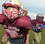 The New Britain Jr. Hurricanes participate in a Heads Up Football clinic on Oct. 9 in New Britain, Conn. The program is teaching kids safer tackling across the country.