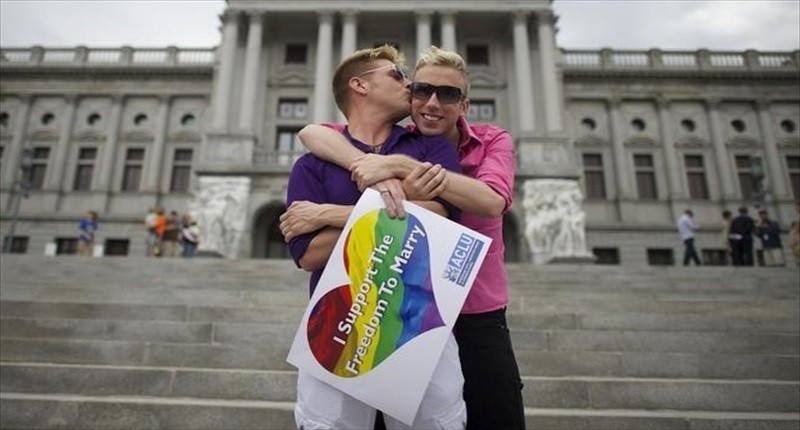 Mike Woods, 28, and Brandon Parsons, 30, embrace on the Pennsylvania State Capital steps following a rally with gay rights supporters after a ruling struck down a ban on same sex marriage in Harrisburg, Pennsylvania on May 20, 2014.  Photo by Mark Makela for Reuters.