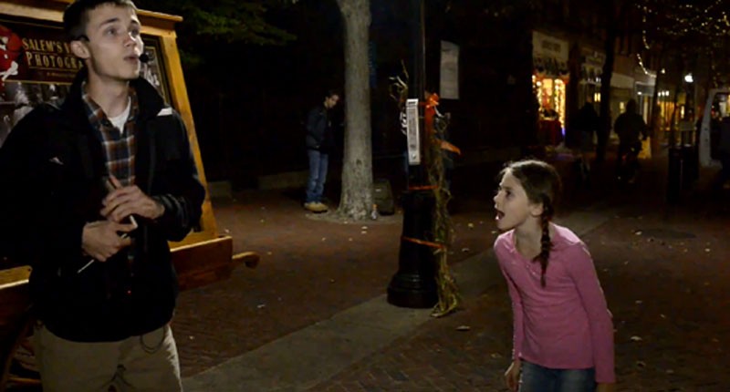 Young girl mocks a street preacher (Screenshot/YouTube)
