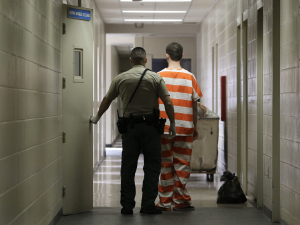 An inmate at the Madera County Jail is taken to an inmate housing unit in Madera, California.
