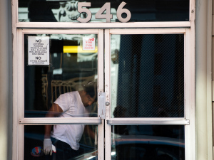 A man on Oct. 23 cleans the lobby of the New York apartment building of Craig Spencer, a doctor who was diagnosed with Ebola after returning from Guinea.