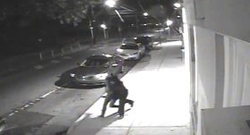 A frame from video reportedly showing the abduction of Carlesha Freeland-Gaither (L) by an unidentified man (R) from a street in the Germantown section of Philadelphia on Nov. 2, 2014.