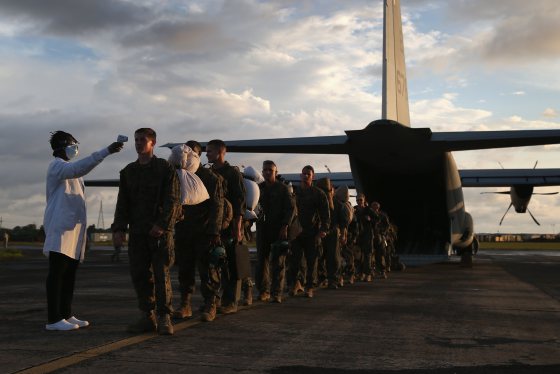 A health worker takes the temperature of U.S. Marines arriving to take part in Operation United Assistance on Oct. 9, 2014 near Monrovia, Liberia.