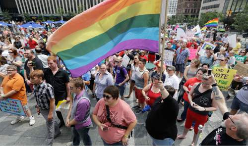 FILE - Hundreds of gay marriage supporters rally on Fountain Square, Wednesday, Aug. 6, 2014, in Cincinnati. Three judges of the 6th U.S. Circuit Court of Appeals in Cincinnati are set to hear arguments Wednesday in six gay marriage fights from four states, Kentucky, Michigan, Ohio and Tennessee. (AP Photo/Al Behrman)