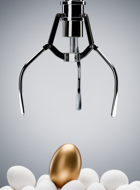 Mechanical claw reaching for golden egg