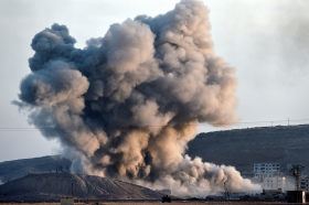 An allied air strike hits a hill in Kobani Wednesday near where ISIS fighters had planted their flag.