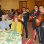 Mariachis serenade Barbara Storz at her recent retirement dinner in Edinburg. Seated next to Storz is her husband, Edwin. (AgriLife Communications photo by Rod Santa Ana)