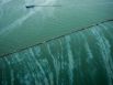 A sheen is seen on the water as a vessel works near the Galveston Jetties on Sunday, March 23, 2014, in Galveston, Texas. Dozens of ships are in evolved in clean-up efforts to remove oil that spilled into Galveston Bay after a ship and barge collided near the Texas City dike on Saturday afternoon.