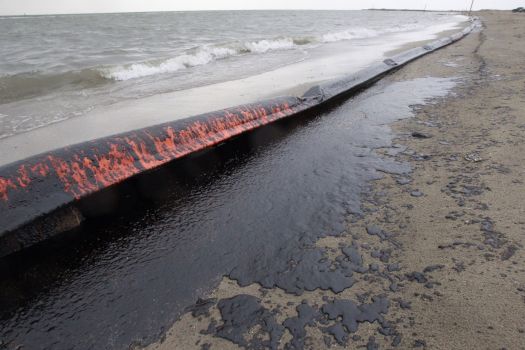 An oil covered boom is washed ashore on the beach area along Boddeker Rd. on the east end of Galveston near the ship channel Sunday, March 23, 2014 in Galveston. Photo: Melissa Phillip, Houston Chronicle