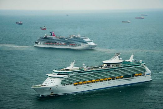 The Royal Caribbean Navigator of the Seas and the Carnival Magic sit idle with dozens of other ships off the coast of Galveston, Texas on Sunday, March 23, 2014. At least 33 vessels, including two cruise ships, are waiting to enter the Houston Ship Channel from the Gulf of Mexico after a ship and barge collided near the Texas City dike on Saturday afternoon. Photo: Smiley N. Pool, Houston Chronicle / © 2014  Houston Chronicle