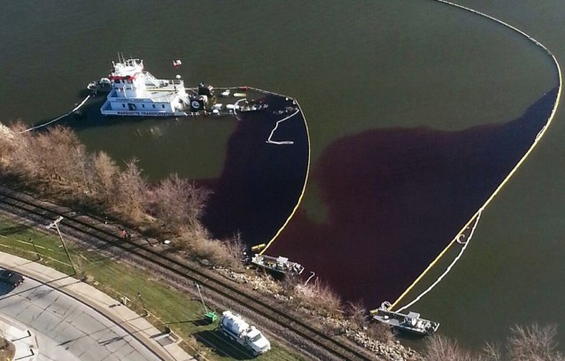 This aerial photo provided by the U.S. Fish and Wildlife Service shows a partially sunken towboat that spilled oil into the Mississippi River in LeClaire, Iowa, Wednesday, Nov. 27, 2013. 