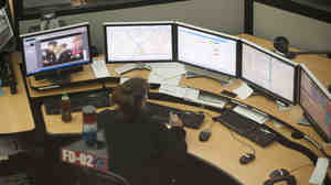 The Fairfax County 911 Center in Virginia takes calls during Hurricane Sandy in 2012. It was relatively easy to locate callers when most people used landlines. But most 911 calls now come from cellphones, which can pinpoint a callers' location only within 100 to 300 meters.
