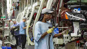 Workers assemble Volkswagen Passat sedans at the German automaker's plant in Chattanooga, Tenn., on June 12, 2013. The automaker announced a new policy Wednesday that would allow interaction with labor unions at the plant.