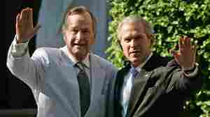 Former President George W. Bush (right) and his father, former President George H.W. Bush, wave as they leave a family wedding in Washington, D.C., in May 2006.